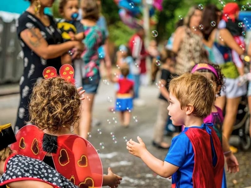 Feijoada deliciosa servida na Arena PG durante o Carnaval com crianças se divertindo ao fundo