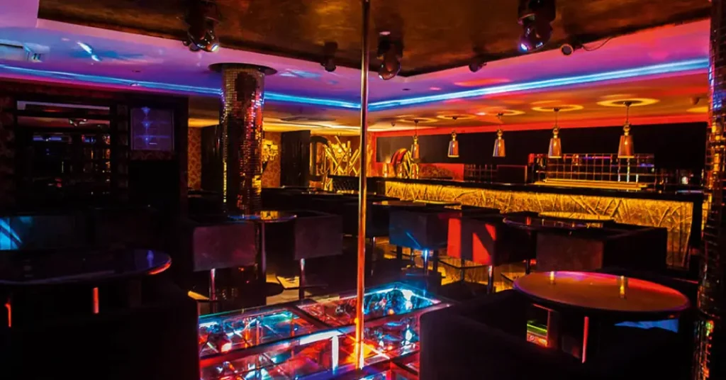 Vista panorâmica de uma balada liberal luxuosa em São Paulo com iluminação neon.